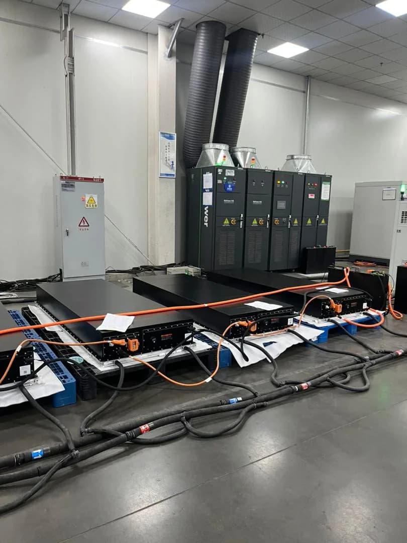 Battery packs connected to power electronics during factory testing.
