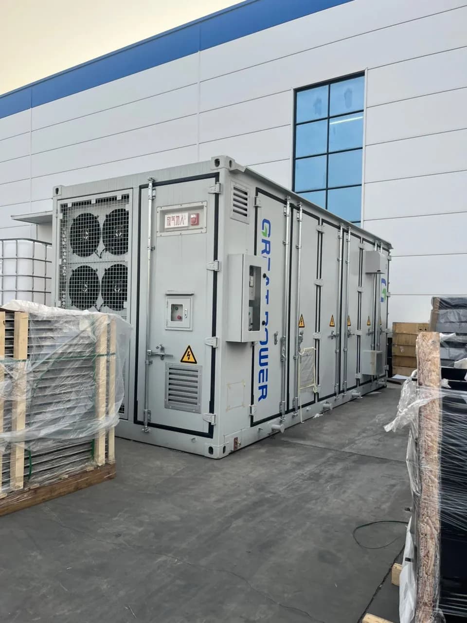 Great Power outdoor energy storage cabinet beside an industrial facility.