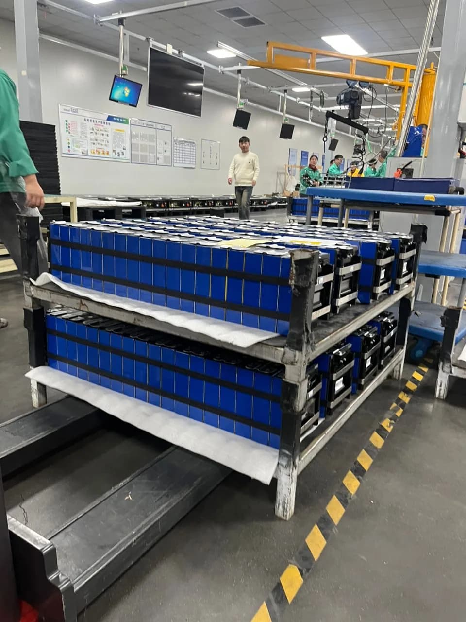 Factory team working on a lithium battery module production line.